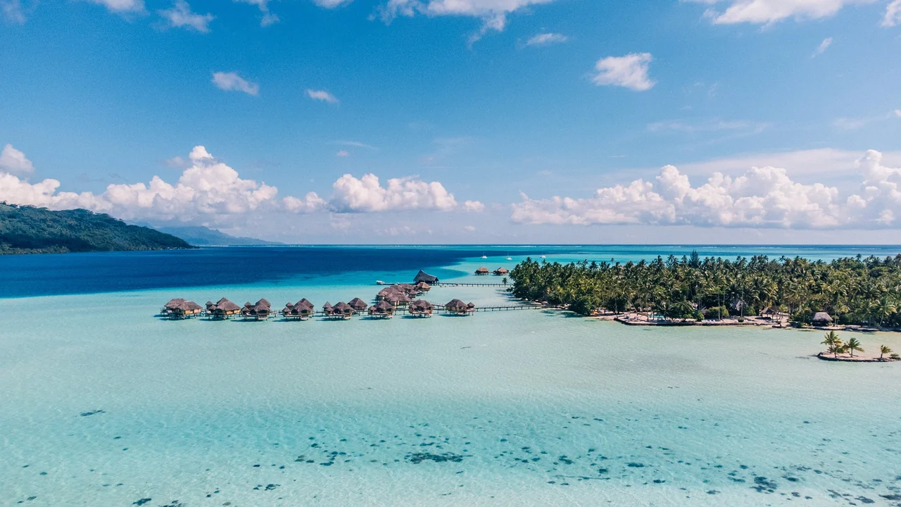 Thatched overwater bungalows on a turquoise lagoon