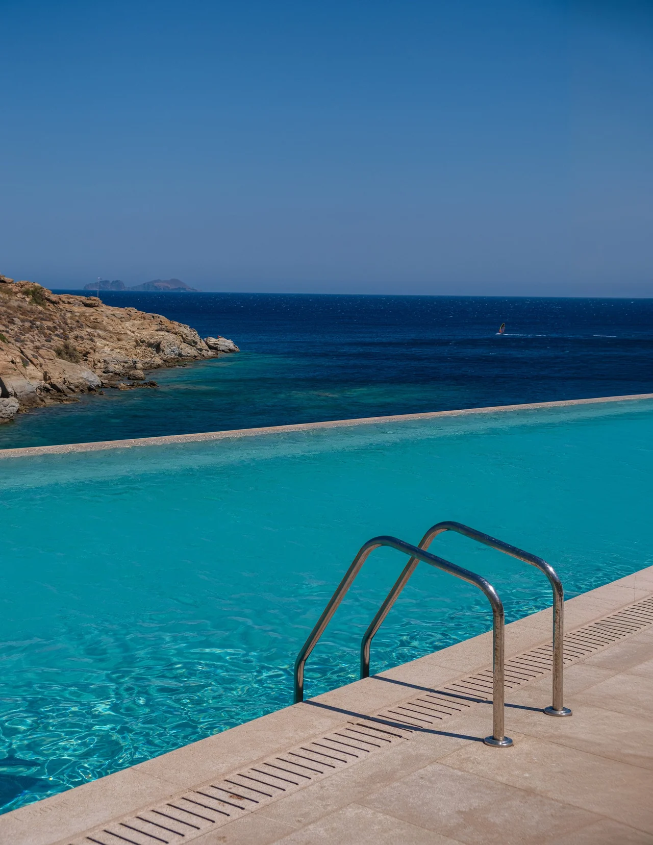 An infinity pool edge above a rocky cove